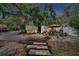 Home featuring a cozy outdoor seating area and colorful pathway leading to the entrance at 675 64Th S Ave, St Petersburg, FL 33705