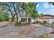 Beautiful home exterior with mature trees, lush landscaping, and a cozy outdoor space at 675 64Th S Ave, St Petersburg, FL 33705