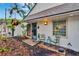 Inviting home exterior featuring a charming courtyard with seating and lush landscaping at 675 64Th S Ave, St Petersburg, FL 33705