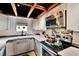 Efficient kitchen with stainless steel microwave, patterned backsplash, and overhead wood beam decor at 675 64Th S Ave, St Petersburg, FL 33705