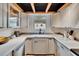 Updated kitchen with white cabinets, modern appliances, and ample counter space with garden window at 675 64Th S Ave, St Petersburg, FL 33705