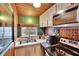 Compact kitchen featuring modern appliances, copper backsplash, and a bright window at 675 64Th S Ave, St Petersburg, FL 33705