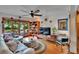 Bright living room featuring stylish decor, hardwood floors, plentiful windows, and a modern ceiling fan at 675 64Th S Ave, St Petersburg, FL 33705