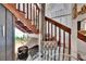 Wooden staircase next to a seating area decorated with a plant and a glass table at 675 64Th S Ave, St Petersburg, FL 33705