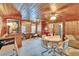 Charming living room boasts wood paneling, cozy seating, and a vintage aesthetic at 675 64Th S Ave, St Petersburg, FL 33705