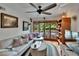 Bright living room featuring stylish decor, hardwood floors, plentiful windows, and a modern ceiling fan at 675 64Th S Ave, St Petersburg, FL 33705