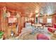 Comfortable living area featuring wood paneling, round table, and decorative furnishings at 675 64Th S Ave, St Petersburg, FL 33705