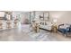 Open-concept living room featuring tile floors, modern furnishings, and an eat-in kitchen bar top at 6851 Broad River Ave, Land O Lakes, FL 34638