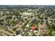 Aerial view of a residential neighborhood featuring lush landscaping and a pond at 6897 18Th N St, St Petersburg, FL 33702