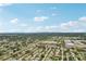 Aerial view of residential neighborhood with mature landscaping and a city skyline in the distance at 6897 18Th N St, St Petersburg, FL 33702