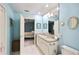Bright bathroom featuring double sinks, granite countertop, and decorative mirror at 6897 18Th N St, St Petersburg, FL 33702