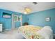 Relaxing bedroom featuring blue walls, large ceiling fan, and natural light at 6897 18Th N St, St Petersburg, FL 33702