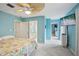 Light and airy bedroom with cool blue walls, ceiling fan, and ensuite bathroom at 6897 18Th N St, St Petersburg, FL 33702