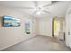 Bright bedroom featuring a ceiling fan, neutral paint, and a mounted television at 6897 18Th N St, St Petersburg, FL 33702