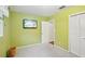 Bedroom with light green walls, carpet flooring and bright light from the window at 6897 18Th N St, St Petersburg, FL 33702