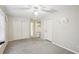 Bedroom featuring neutral walls and carpet plus white closet doors and trim at 6897 18Th N St, St Petersburg, FL 33702