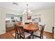 The dining room with hardwood floors is open to the living room area at 6897 18Th N St, St Petersburg, FL 33702