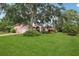 A single-Gathering house with a large front lawn and mature trees at 6897 18Th N St, St Petersburg, FL 33702