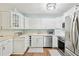 Bright, updated kitchen with white cabinets, stainless steel appliances, and hardwood floors at 6897 18Th N St, St Petersburg, FL 33702