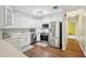 Updated kitchen with white cabinets, stainless steel appliances, and hard wood floors at 6897 18Th N St, St Petersburg, FL 33702