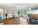 Bright living room with hardwood floors, light blue walls, and large glass doors to patio at 6897 18Th N St, St Petersburg, FL 33702