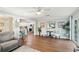 Bright living room with light blue walls, hard wood floors, and view into the kitchen at 6897 18Th N St, St Petersburg, FL 33702