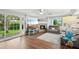 Open-concept living area with wood flooring, fireplace, and lots of natural light at 6897 18Th N St, St Petersburg, FL 33702