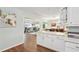 Living room has hardwood floors with an open view to the dining room and kitchen at 6897 18Th N St, St Petersburg, FL 33702