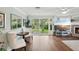 Bright living room features wood floors, sliding glass doors, and a fireplace at 6897 18Th N St, St Petersburg, FL 33702
