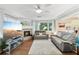 Living room features wood flooring, neutral decor, and a cozy fireplace at 6897 18Th N St, St Petersburg, FL 33702