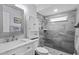 Renovated bathroom with stone floors, tiled shower, and modern vanity with plenty of storage at 715 W 109Th Ave, Tampa, FL 33612