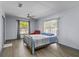 Calming bedroom with wood floors, bright windows and a ceiling fan, complete with a brass bed at 715 W 109Th Ave, Tampa, FL 33612