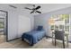 Cozy bedroom with a ceiling fan, wood floors, and natural light from the window at 715 W 109Th Ave, Tampa, FL 33612