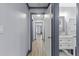 Bright hallway with wood floors, blue-grey trim, and views of the bathroom and other rooms at 715 W 109Th Ave, Tampa, FL 33612