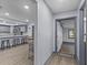Hallway view leading into an open kitchen and dining area with wood floors at 715 W 109Th Ave, Tampa, FL 33612