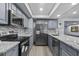 Modern kitchen with gray cabinets, granite countertops, and stainless steel appliances at 715 W 109Th Ave, Tampa, FL 33612