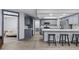 Modern kitchen featuring gray cabinetry, a large island with seating, and stainless steel appliances at 715 W 109Th Ave, Tampa, FL 33612