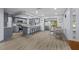 Open-concept kitchen with gray cabinets, stainless steel appliances, and a spacious island with seating at 715 W 109Th Ave, Tampa, FL 33612
