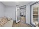 Cozy living room with light grey walls, wood floors, and a view through the open patio door at 715 W 109Th Ave, Tampa, FL 33612