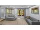 Spacious living room with wood floors, natural light, ceiling fans, and neutral-toned furniture at 715 W 109Th Ave, Tampa, FL 33612