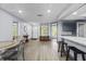 Open floor plan showcasing a kitchen island, dining area, and living room with ample natural light at 715 W 109Th Ave, Tampa, FL 33612