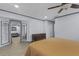 Large main bedroom with wood floors and a view into the living room through a window at 715 W 109Th Ave, Tampa, FL 33612