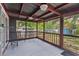 Relaxing screened porch with a painted wood floor and metal furniture at 715 W 109Th Ave, Tampa, FL 33612