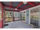 Spacious screened porch with wood railing and sliding doors to the interior at 715 W 109Th Ave, Tampa, FL 33612