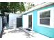 Backyard view of the home shows door to bonus space and fenced exterior at 7510 N Tampania Ave, Tampa, FL 33614