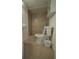 This bathroom features tiled walls, a toilet, and a cabinet for storing toiletries at 7510 N Tampania Ave, Tampa, FL 33614