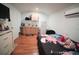 The bedroom features a bed, a TV, a kitchenette, and an air conditioner at 7510 N Tampania Ave, Tampa, FL 33614