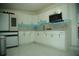 Updated kitchen featuring white cabinets, modern appliances, and marbled tile flooring at 7510 N Tampania Ave, Tampa, FL 33614