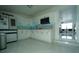 Updated kitchen featuring white cabinets, modern appliances, and marbled tile flooring at 7510 N Tampania Ave, Tampa, FL 33614