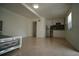 The living area offers a bed, a kitchenette, tile flooring, and natural light through the window at 7510 N Tampania Ave, Tampa, FL 33614